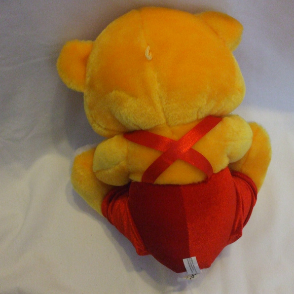Yellow Teddy Bear With Red Pants Holding Flower - Picture 4 of 4